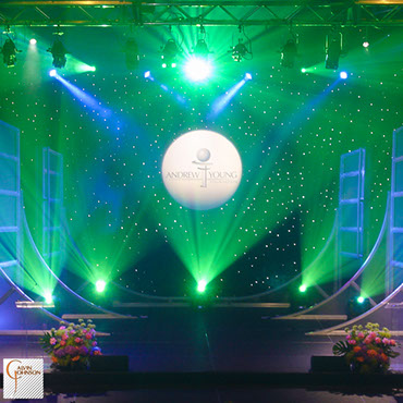 Beams of Green and White Light Shining from a stage