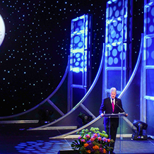 President Bill Clinton Standing at Podium Giving a Speech