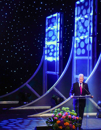 President Bill Clinton Standing at Podium Giving a Speech