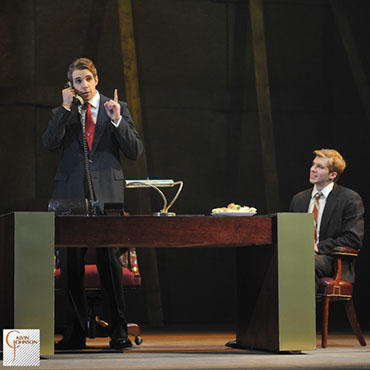 A performance of "Angels In America" at Carnegie Mellon. Roy Cohn Talks on the phone while Joe Pitt waits at his desk.