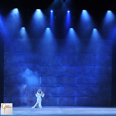 A performance of "Angels In America" at Carnegie Mellon. Blue beams of light and Digital images surround Harper Pitt as she enters Antarctica