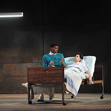 A performance of "Angels In America" at Carnegie Mellon. Prior Walter gets a visit from Belize in his hospital bed.