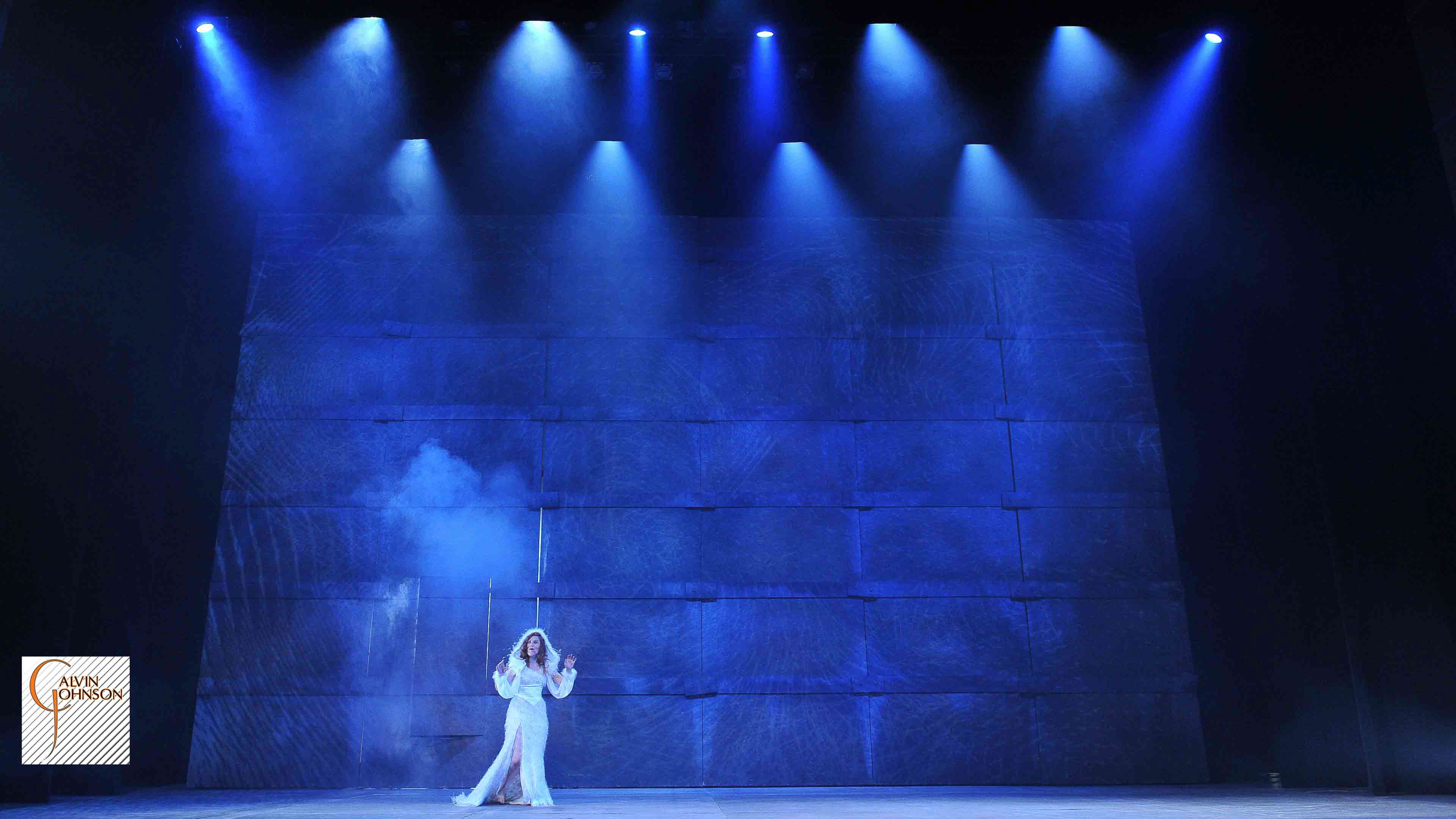 A performance of "Angels In America" at Carnegie Mellon. Blue beams of light and Digital images surround Harper Pitt as she enters Antarctica