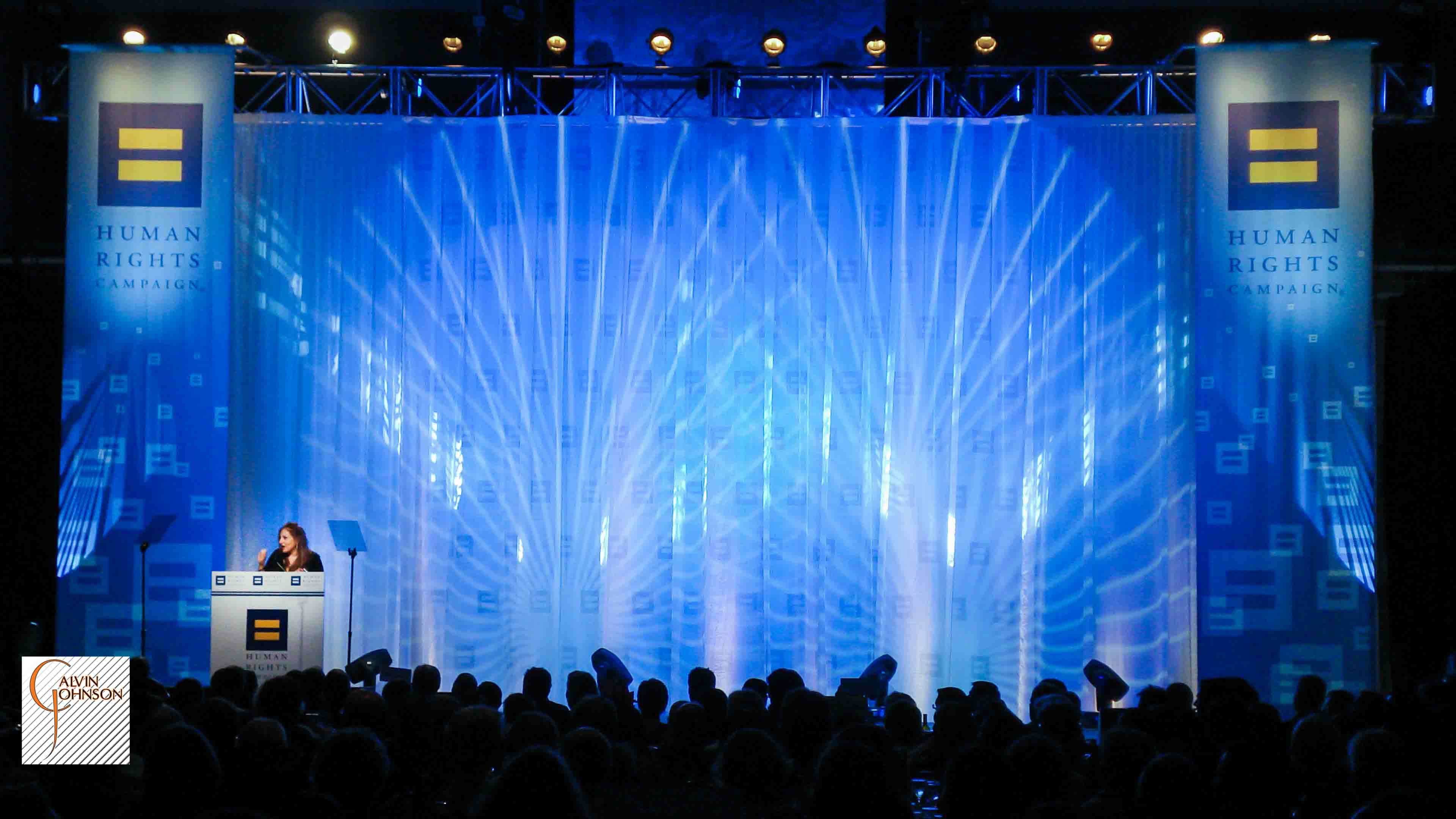 Award winner at the podium giving a speech on stage.