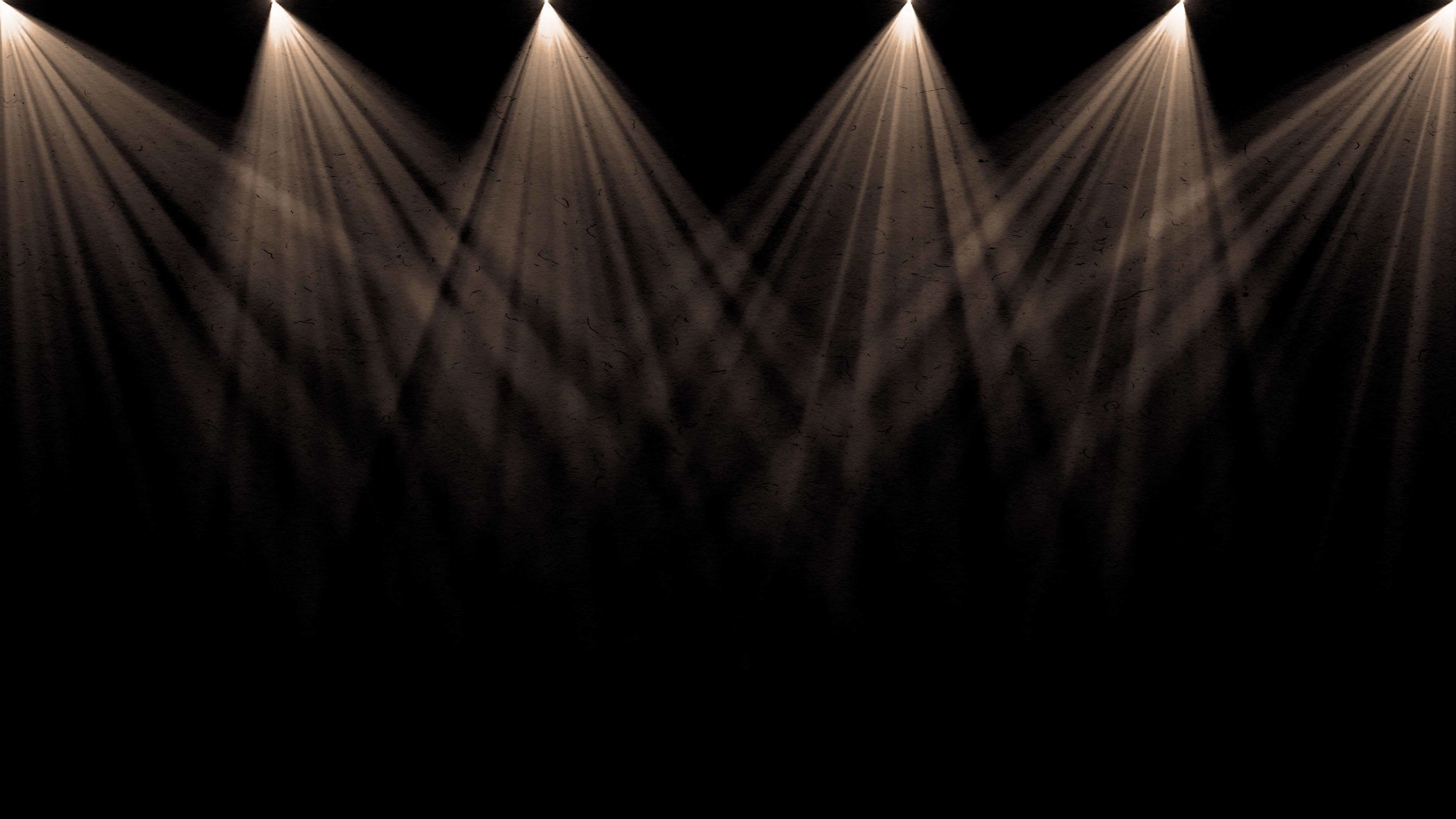 Fractured beams of light shinning from above thru haze.