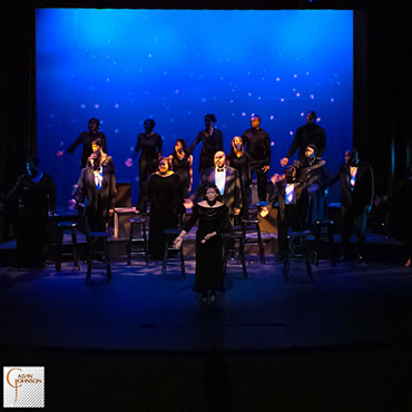 Choral members singing a musical number on stage from The Black Nativity Play.