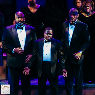 Choral members singing a musical number on stage from The Black Nativity Play.