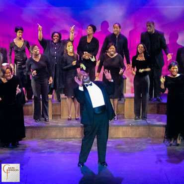 Choral members singing a musical number on stage from The Black Nativity Play.