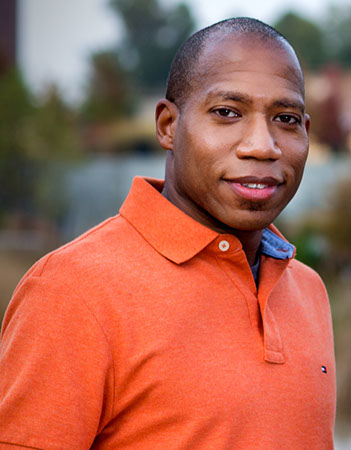 Image of Calvin G. Johnson wearing an orange polo shirt.